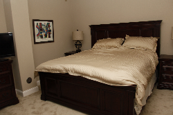 a large bed with tan sheets