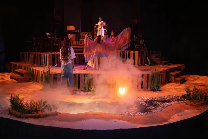 students performing on stage with smoke all around them