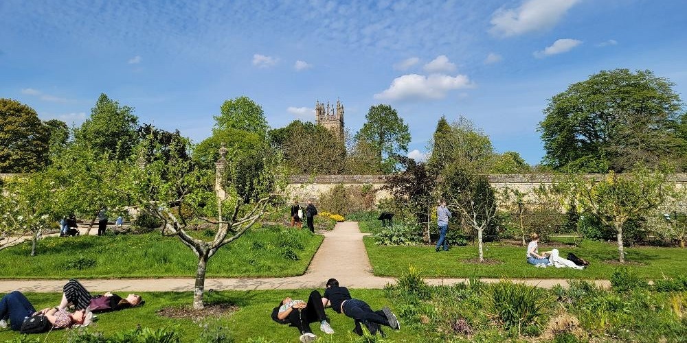 study abroad students laying in the grass in Oxford, England
