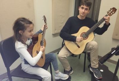 Ben Richardson teaching with guitar