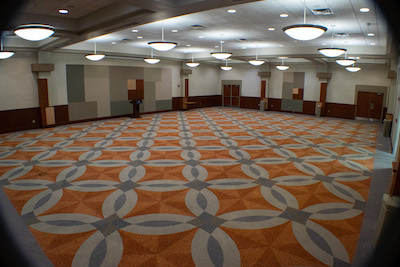 covered circular tables with artworks on the wall