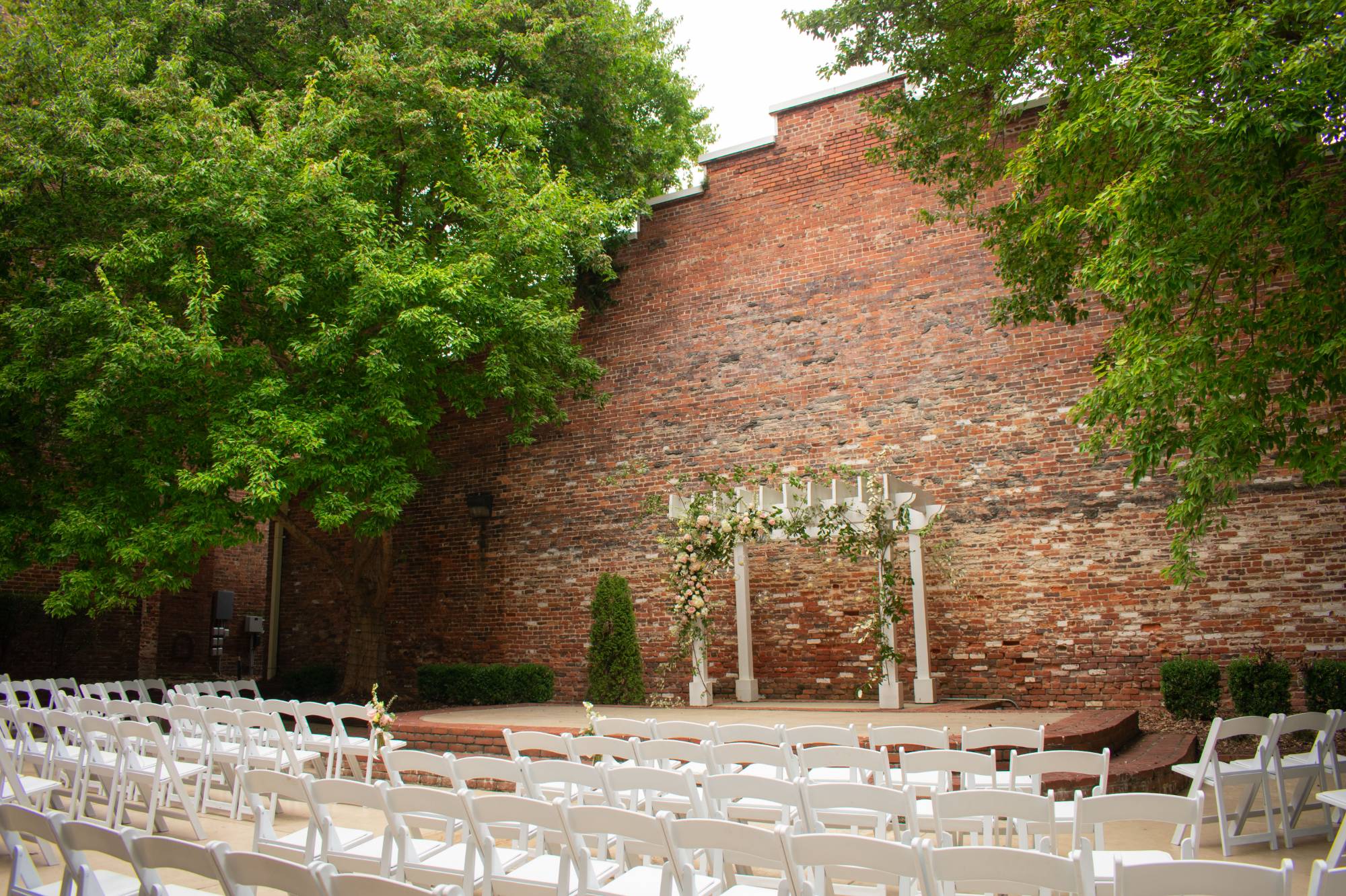 several tables with place settings outside of a building